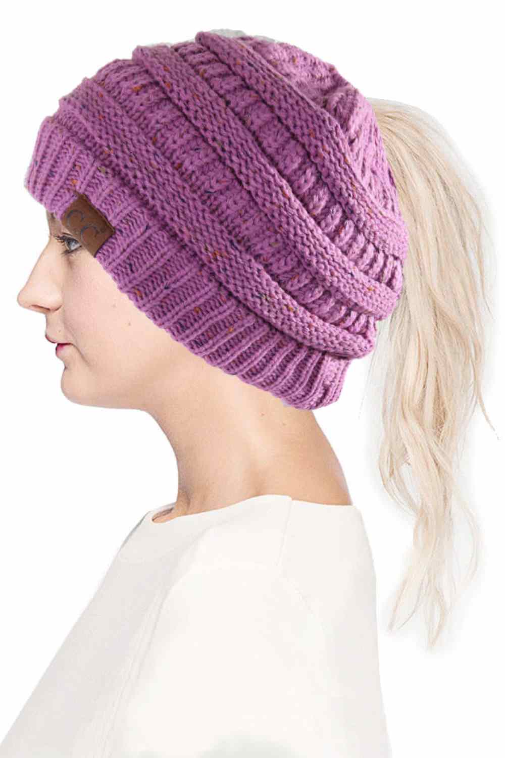 Lavender The C.C Confetti Ponytail Messy Bun Beanie features a soft knit design with subtle confetti flecks for a fun, playful look. Designed with a convenient opening for ponytails or messy buns, it keeps you warm while allowing you to style your hair comfortably.