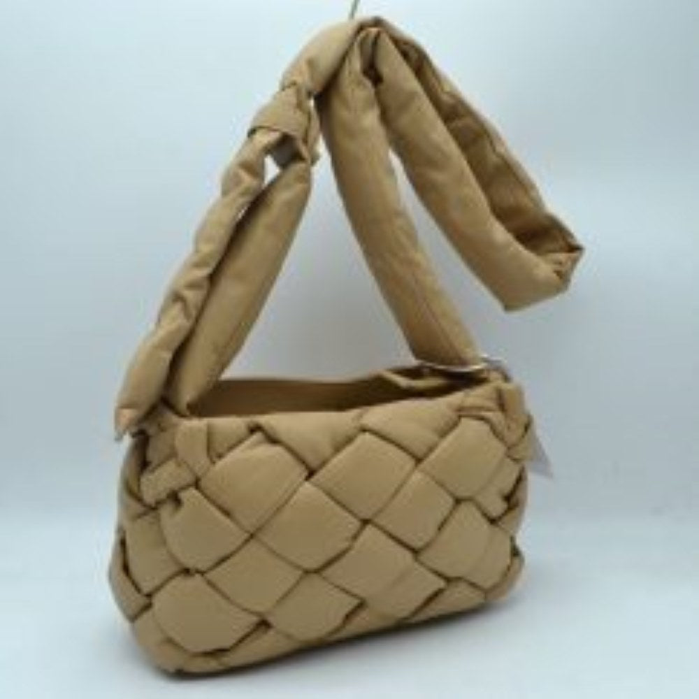 Nude This unique handbag features a distinctive woven main compartment crafted with a thick, intertwined design for a modern, textured aesthetic. Perfect for everyday use, the bag is equipped with a generous open-top storage compartment to easily accommodate your daily essentials. A wide, matching puffy shoulder strap features a stylish knot detail near the base, ensuring comfortable carrying while adding a contemporary look to your outfit.