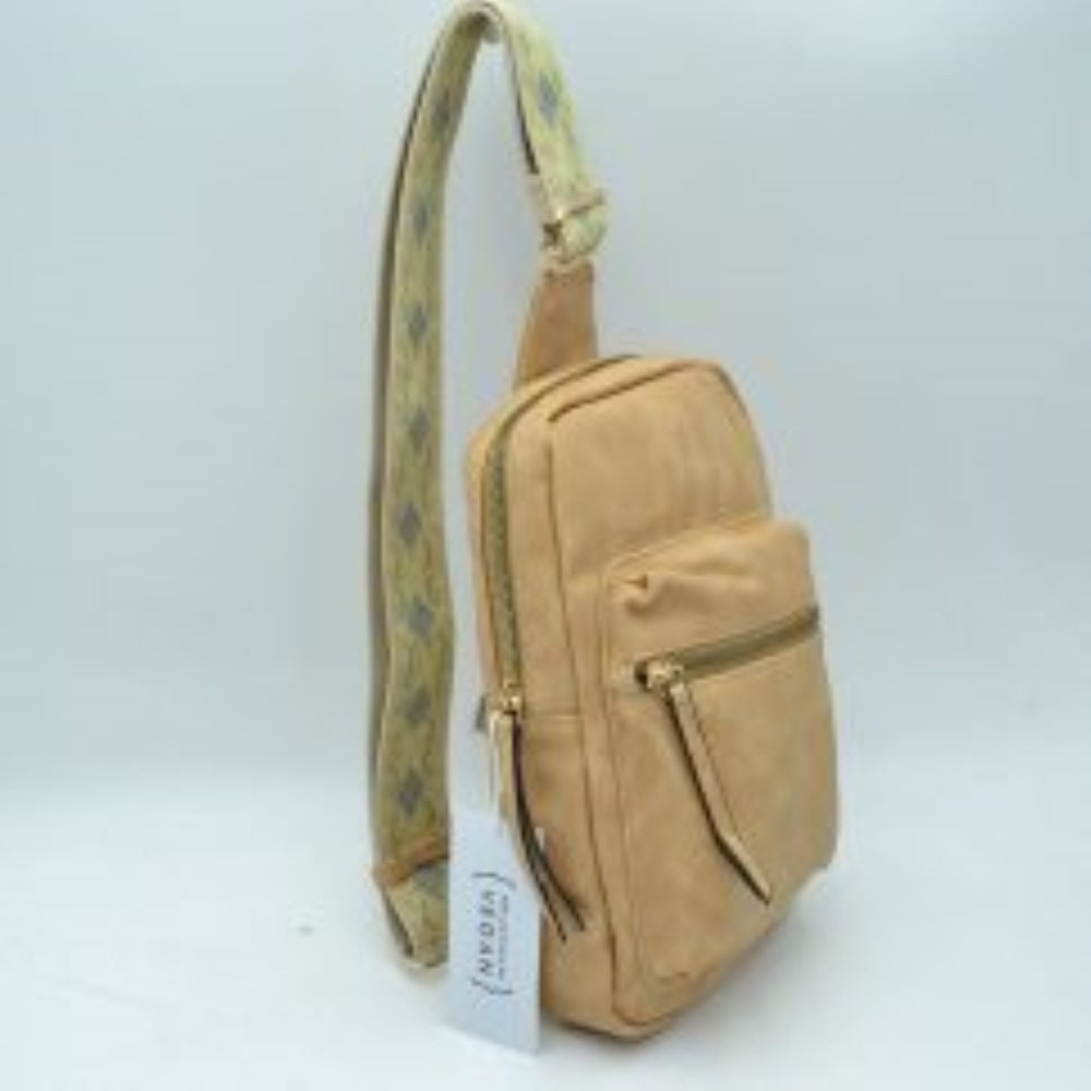 Nude This functional sling bag features a contoured silhouette designed for comfortable everyday use and hands-free convenience. It offers structured storage compartments, including a main zippered section and a front zippered pocket equipped with extended pull tabs. The wide, adjustable shoulder strap showcases an intricate embroidered geometric pattern and features a metallic slide buckle for a customizable fit across the body, attaching securely with durable metal hardware.