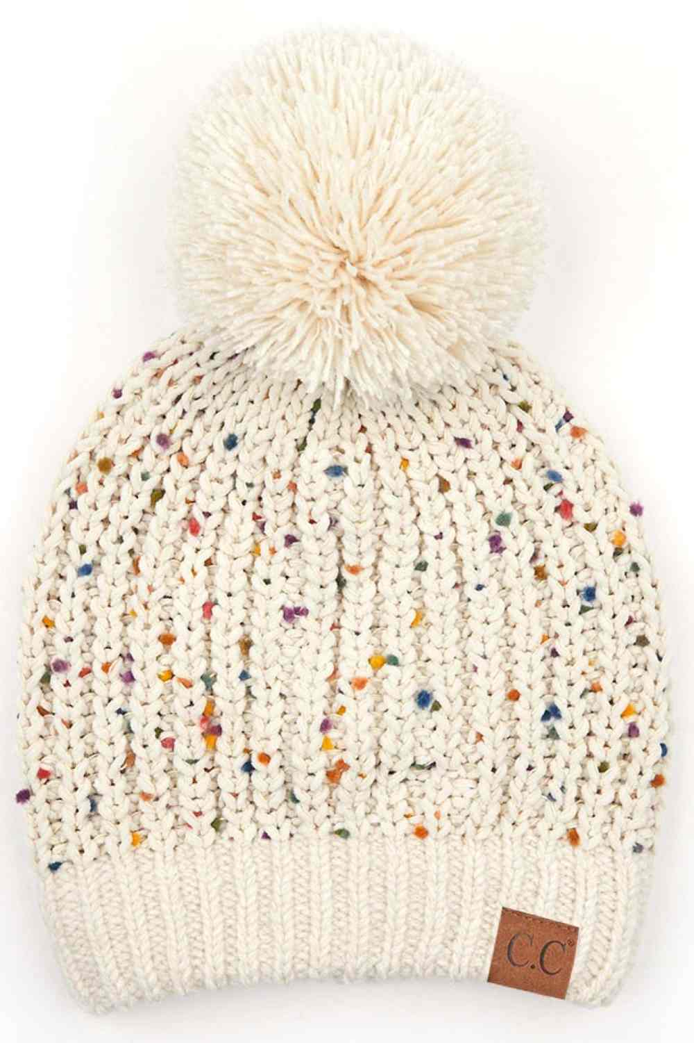 Oatmeal Elevate your winter wardrobe with this C.C Confetti Chenille Knit Pom Beanie, crafted from a premium blend of 50% acrylic, 43% polyester, and 7% nylon for durability and comfort. The soft chenille knit texture pairs beautifully with a cozy pom detail, making it perfect for both indoor and outdoor wear.