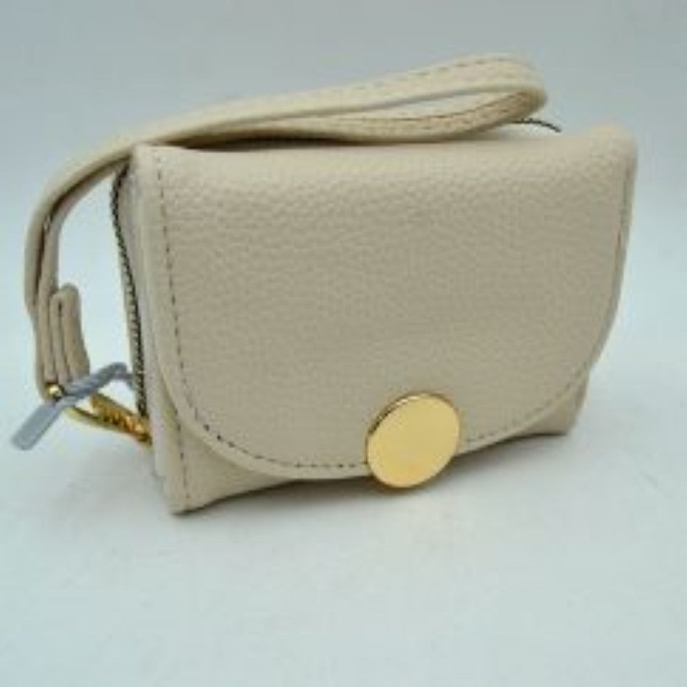 Oatmeal This compact everyday wallet features a pebbled, textured exterior designed for practical multi-compartment storage. It includes a secure, top zip-around section with metallic teeth alongside a front fold-over flap portion accented by a prominent round metallic button closure. For convenient carrying during daily errands, it comes equipped with a slim, matching wristlet strap attached to the side hardware.