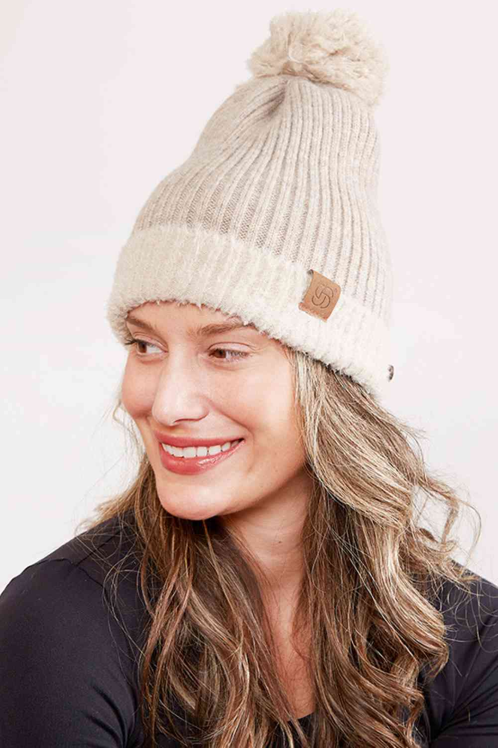 Oatmeal Cozy up this season with our Ribbed Brim Button Pom Beanie, designed for warmth and style. Crafted from 100% acrylic, this soft knit hat features a classic ribbed texture, decorative buttons, and a charming pom pom on top.
