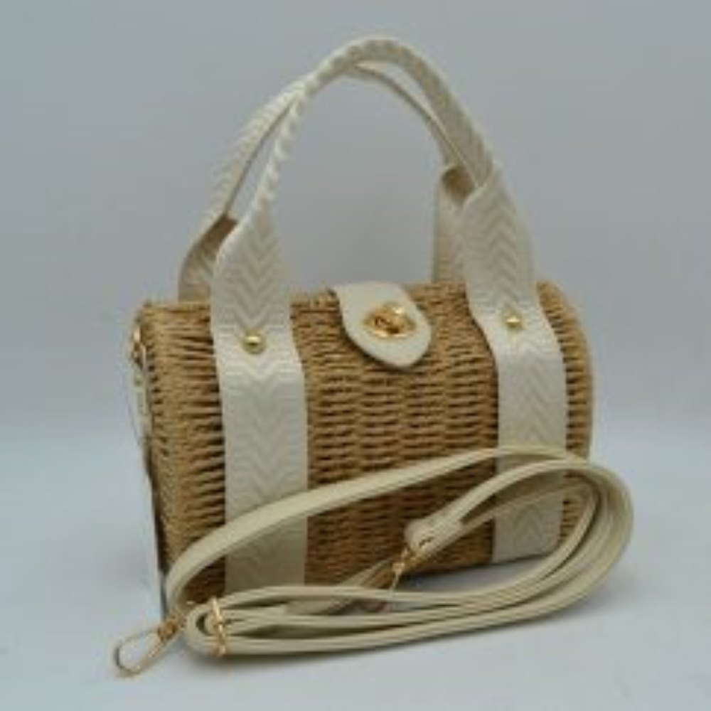 Off White This structured barrel-shaped handbag features a textured, tightly woven body designed for unique everyday style. It is equipped with dual top handles featuring a distinctive chevron pattern, which are secured to the front and back panels with polished metallic studs. A central tab with a smooth texture extends over the top opening, fastening securely with a metallic turn-lock closure on the front.