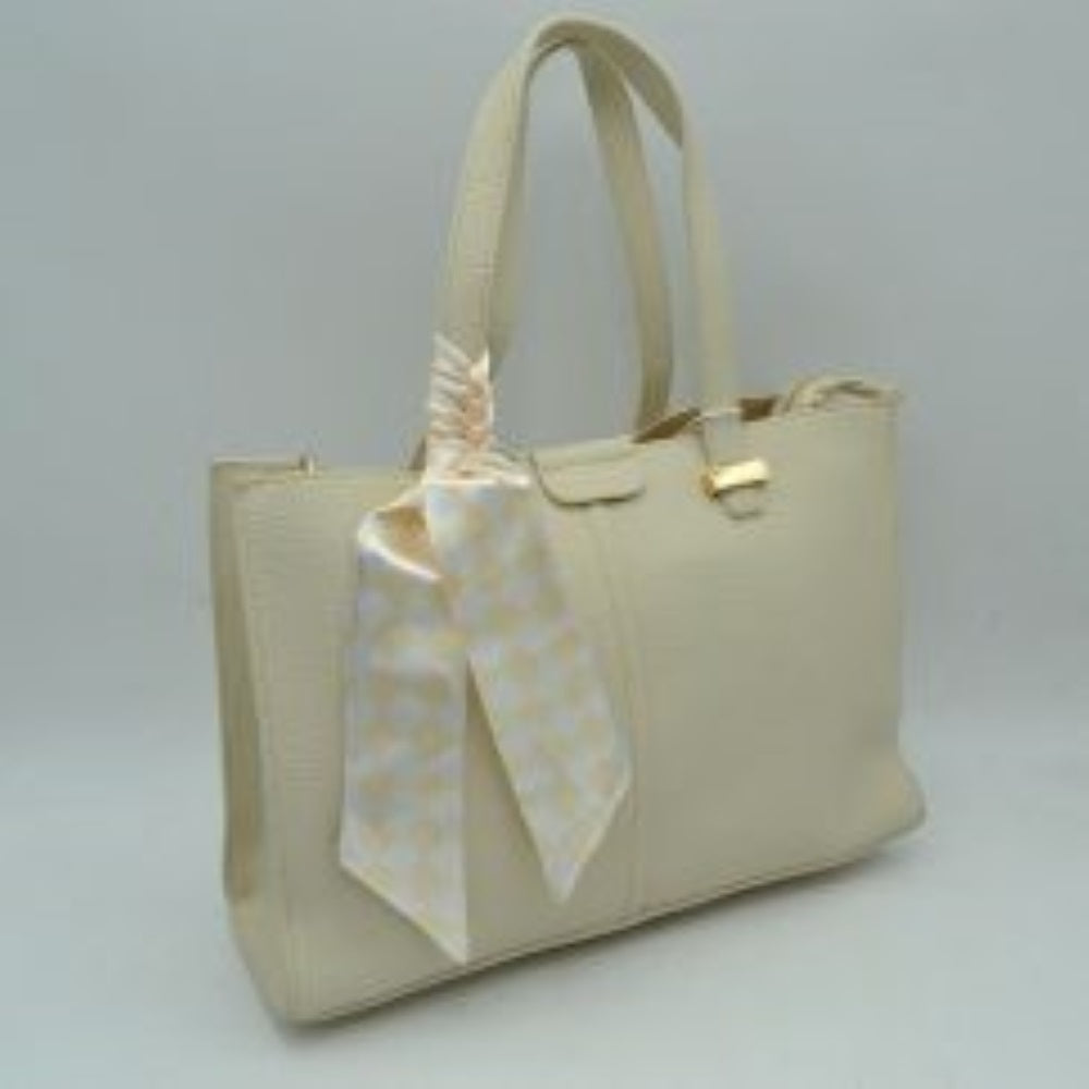 Of-White This structured everyday tote bag features a distinct pebbled textured body designed for organized daily use. It offers a spacious main compartment equipped with a secure top zipper closure alongside a detached, adjustable shoulder strap that attaches via polished metal hardware. Flat double top handles are anchored neatly to the front and back panels with metallic hardware accents