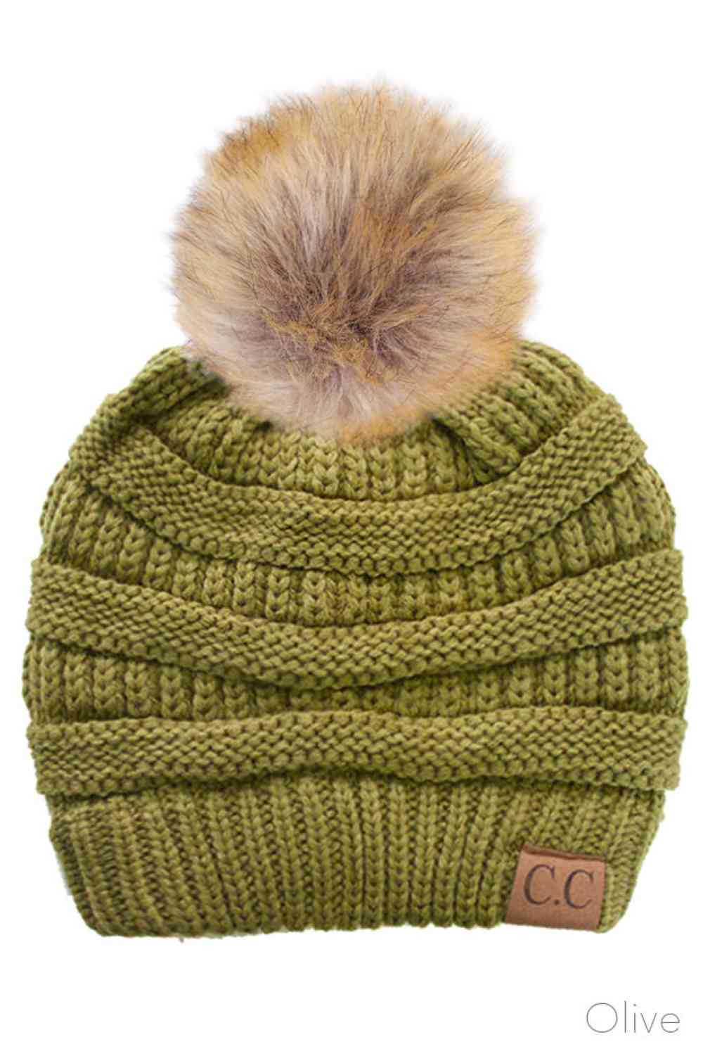 Olive Stay warm and cozy with this classic C.C Pom Pom Knit Beanie, crafted from 100% soft acrylic for all-day comfort. The ribbed knit design adds texture and durability, while the signature pom pom on top brings a playful touch to any winter outfit. One size fits most, making it the perfect accessory for everyone. Ideal for cold weather adventures or casual everyday wear.