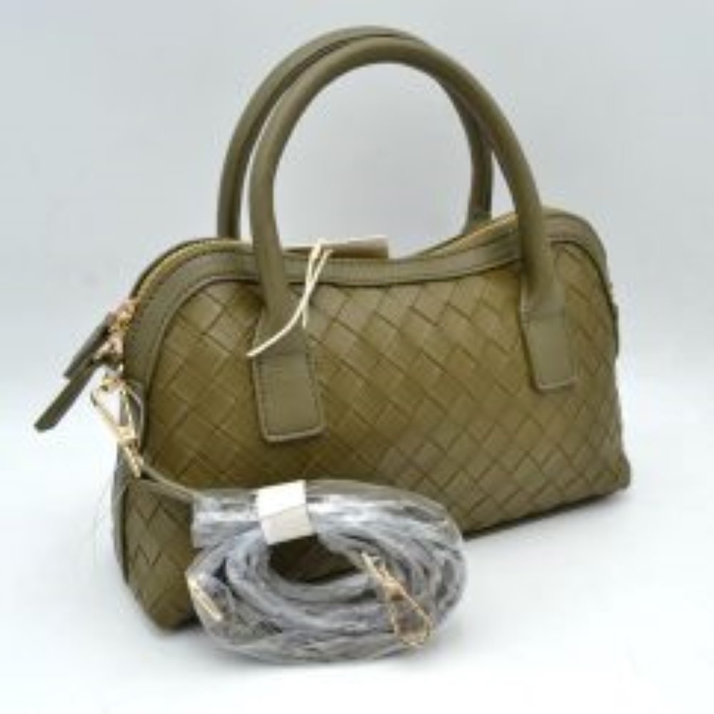 Olive This structured satchel features an intricate woven exterior design with a classic dome silhouette, making it a sophisticated choice for elevated everyday use. It is detailed with sturdy, rounded dual top handles and a decorative hanging leather clochette charm for a touch of timeless style. A gold-tone double-zipper closure secures the main storage compartment, and the bag comes complete with a matching detachable long shoulder strap for versatile crossbody styling options.