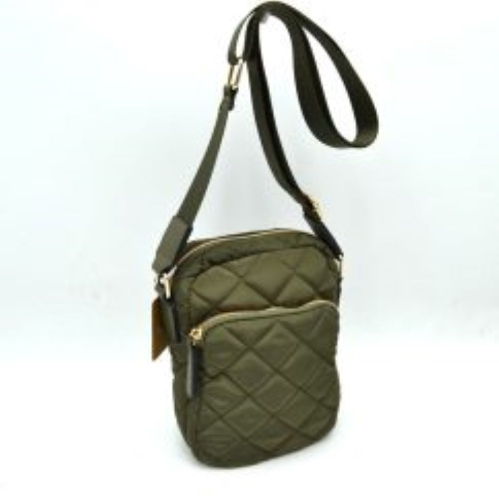 Olive This structural trapeze handbag showcases a clean exterior finish and distinct flared side panels, offering an elegant aesthetic for everyday use. It features unique rounded top handles shaped like segmented bamboo rings, which are attached securely via wide decorative tabs and metallic hardware on the front and back. A top zipper closure with an extended pull tab opens up to a secure main storage compartment, keeping all your essential items safe and neatly organized.