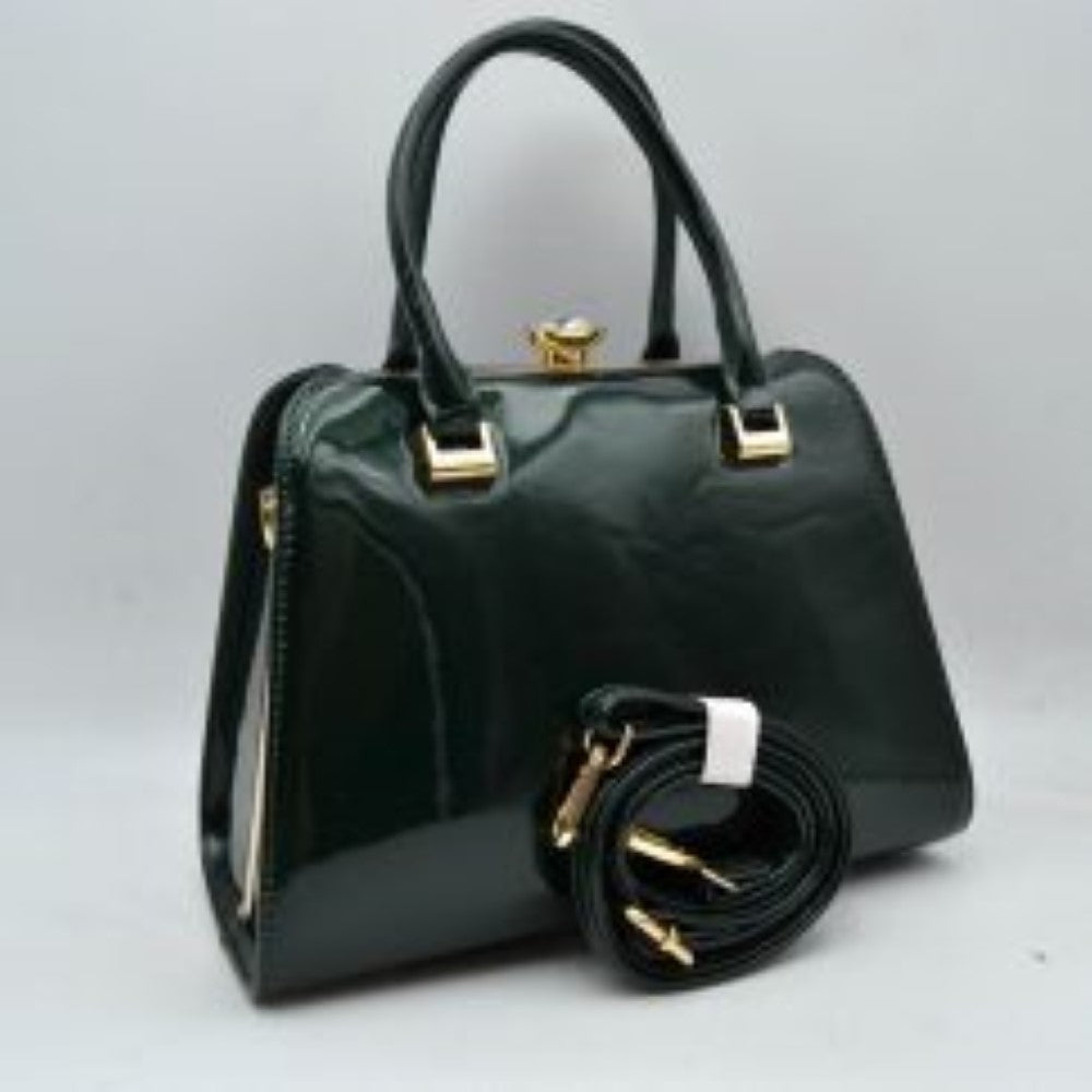 Olive This sophisticated frame handbag features a high-shine patent finish and a structured trapezoidal silhouette, making it an elegant choice for evening or formal wear. Designed with a classic frame top closure, it is secured by a distinctive pearl-accented gold-tone twist lock. Dual rolled top handles attached via polished metallic hardware allow for stylish handheld carrying, while an included detachable shoulder strap with gold-tone clasps offers versatile hands-free shoulder options.