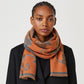 A soft scarf featuring an elegant floral print with a bordered edge and fringe finish. Lightweight yet cozy, this versatile accessory brings warmth and a touch of sophistication to casual and dressy outfits.