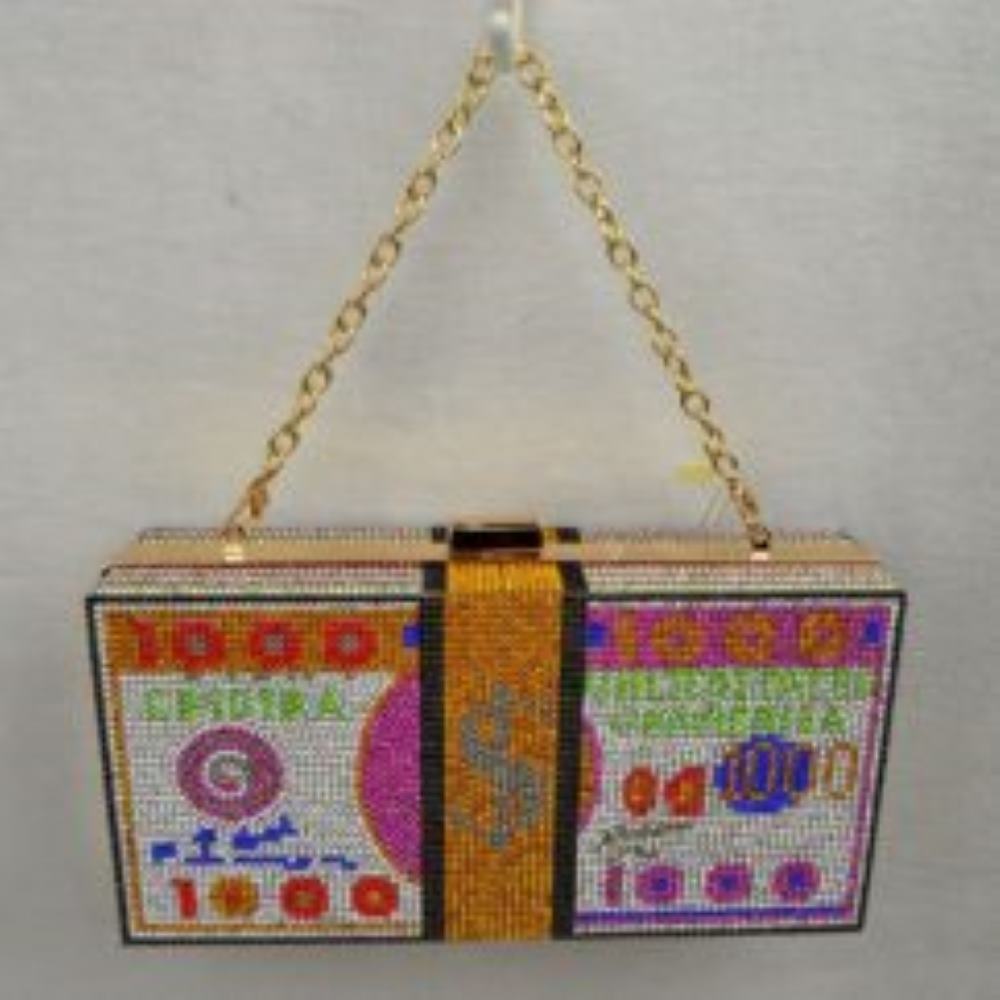 Orange This eye-catching clutch bag features a structured box design completely covered in glittering rhinestones arranged to mimic the appearance of a stacked currency bill, complete with numeric details and a decorative band graphic. Ideal for evening events or adding a bold statement to everyday outfits, it includes a metallic top clasp closure to keep essentials secure and comes equipped with a detachable chain link strap for versatile carrying options as a shoulder bag or a handheld clutch.