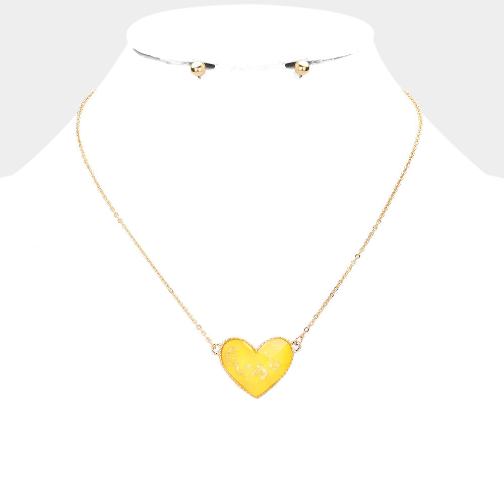Yellow Gold Foil Detailed Heart Pendant Necklace adds a touch of elegance to any outfit. The intricate gold foil detailing highlights the delicate heart pendant, creating a timeless and sophisticated piece. Crafted with high-quality materials, this necklace is sure to make a statement and elevate your style.