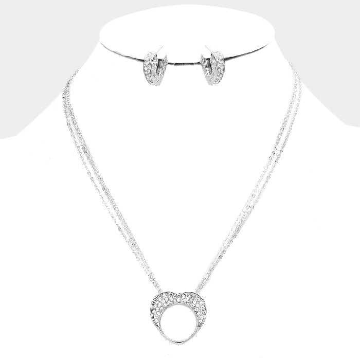 Rhodium Clear Crystal Rhinestone Necklace boasts a beautifully crafted Pave Heart Cut Out Pendant. Stunning and versatile, this necklace will add a touch of sparkle to any outfit. Made with high-quality materials, its durability ensures long-lasting wear. Bring a touch of glamour to your wardrobe with this stunning necklace.