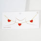 Red Gold Dipped Triple Heart Pendant Necklace adds a touch of romance to any outfit. Crafted with quality and precision, each heart is dipped in genuine gold for a luxurious finish. This necklace is a stunning addition to any jewelry collection, perfect for special occasions or everyday wear.