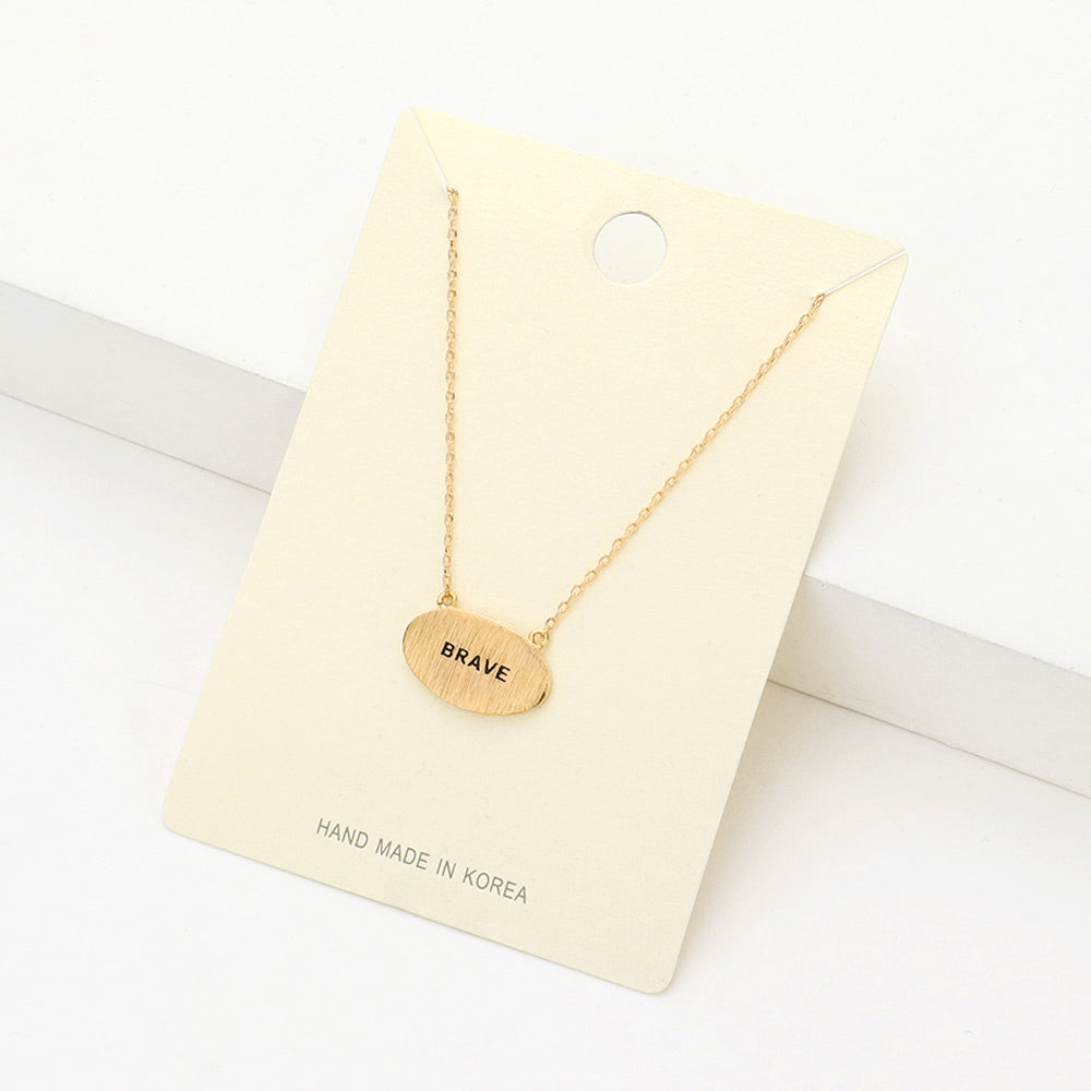 Madeline Love Gold "Brave" Message Brass Oval Metal Pendant Necklace - Necklaces