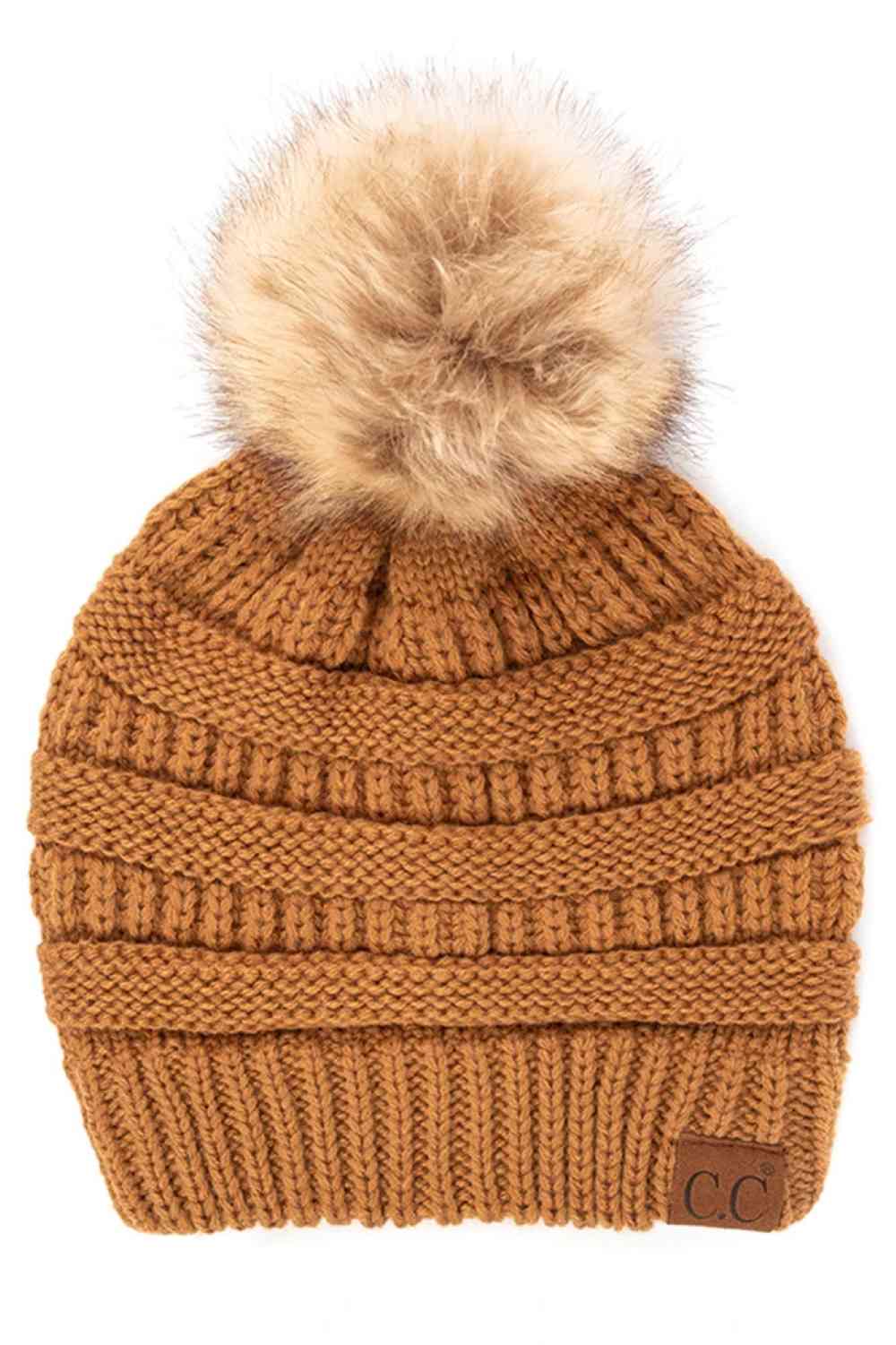 Golden_Walnut Stay warm and cozy with this classic C.C Pom Pom Knit Beanie, crafted from 100% soft acrylic for all-day comfort. The ribbed knit design adds texture and durability, while the signature pom pom on top brings a playful touch to any winter outfit. One size fits most, making it the perfect accessory for everyone. Ideal for cold weather adventures or casual everyday wear.