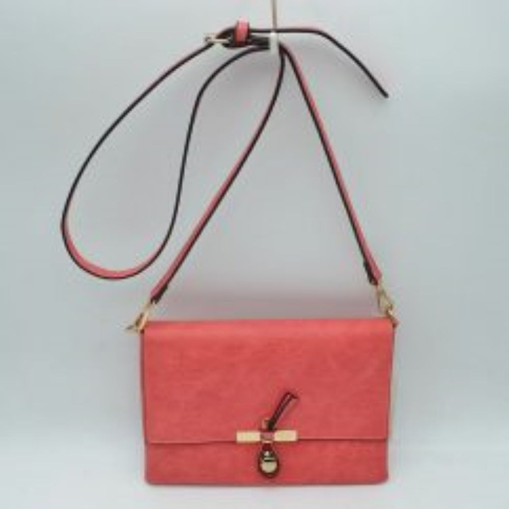 Peach This versatile handbag features a textured finish with a clean foldover flap design, perfect for stylish everyday wear. The front closure is accented with a unique knotted strap detail paired with a polished metallic slider and charm. Designed with a slim profile, it includes a long, adjustable shoulder strap attached via metallic clasps for comfortable hands-free crossbody or shoulder carrying.