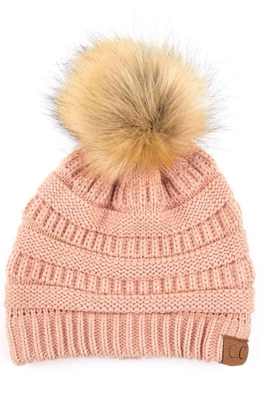 Peach Stay warm and cozy with this classic C.C Pom Pom Knit Beanie, crafted from 100% soft acrylic for all-day comfort. The ribbed knit design adds texture and durability, while the signature pom pom on top brings a playful touch to any winter outfit. One size fits most, making it the perfect accessory for everyone. Ideal for cold weather adventures or casual everyday wear.