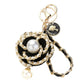 Black Gold Pearl Pointed Faux Leather Braided Chain Deco Flower Key Chain is a stylish and practical addition to any keychain collection. The chain is crafted with faux leather and features a beautiful pearl and deco flower design. It is not only fashionable but also durable and easy to attach to your keys.