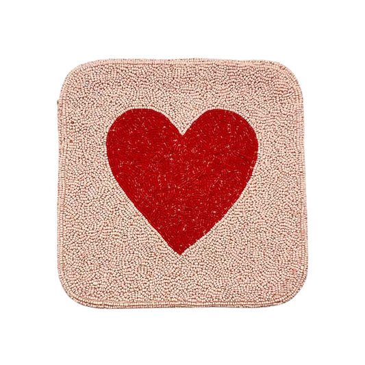 Pink Heart accented crossbody bag is adorned with delicate seed beads, adding a touch of elegance to any outfit. The compact square shape is perfect for carrying your essentials, while the crossbody strap keeps your hands free. The unique design and quality materials make it a must-have accessory for any fashion-forward individual.