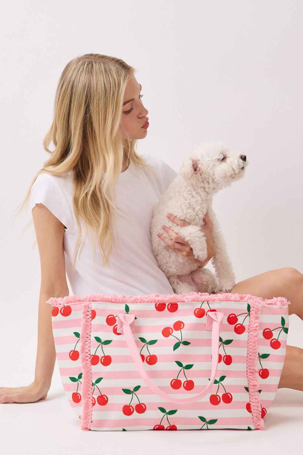 Pink Carry your essentials in style with this Cherry with Stripe Pattern Fringe Medium Tote Bag. Crafted from durable 100% polyester, this versatile bag features a vibrant cherry hue accented with bold stripe patterns and playful fringe detailing. Measuring 14.5" x 11.5" x 7", it offers ample space for daily necessities while maintaining a compact, manageable size. The secure zipper closure keeps your belongings safe, while the convenient inner pocket provides organized storage for smaller items. Perfect fo