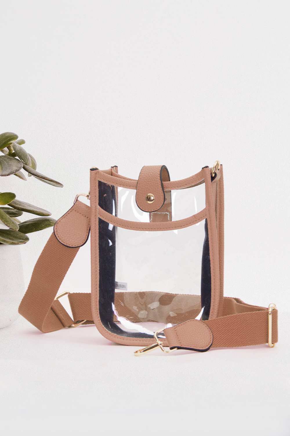 Pink Perfect for concert season and stadium events, this clear crossbody mini bag meets all venue security requirements while keeping your essentials within reach. Crafted from durable 100% PVC, it's easy to clean and built to last through countless outings. Compact yet functional at 8" x 5.8" x 2.3", the adjustable crossbody strap sits comfortably across your body, leaving your hands free. The transparent design lets you quickly locate your phone, keys, and small valuables at a glance.