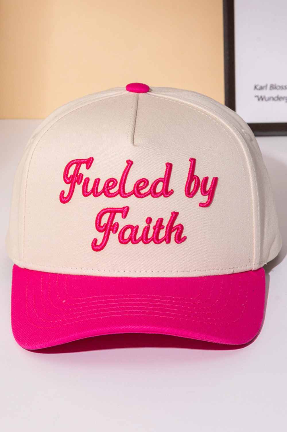 Pink Declare your faith with style in this classic two-tone trucker cap. Featuring bold embroidered lettering that reads "FUELED BY FAITH," this snapback combines comfort with meaningful expression. Crafted from 100% cotton, it's breathable and lightweight for all-day wear. The adjustable snapback closure ensures a perfect fit for one size fits most. Whether you're heading to church, the gym, or casual outings, this cap makes a statement about what drives you. Perfect for believers who wear their conviction