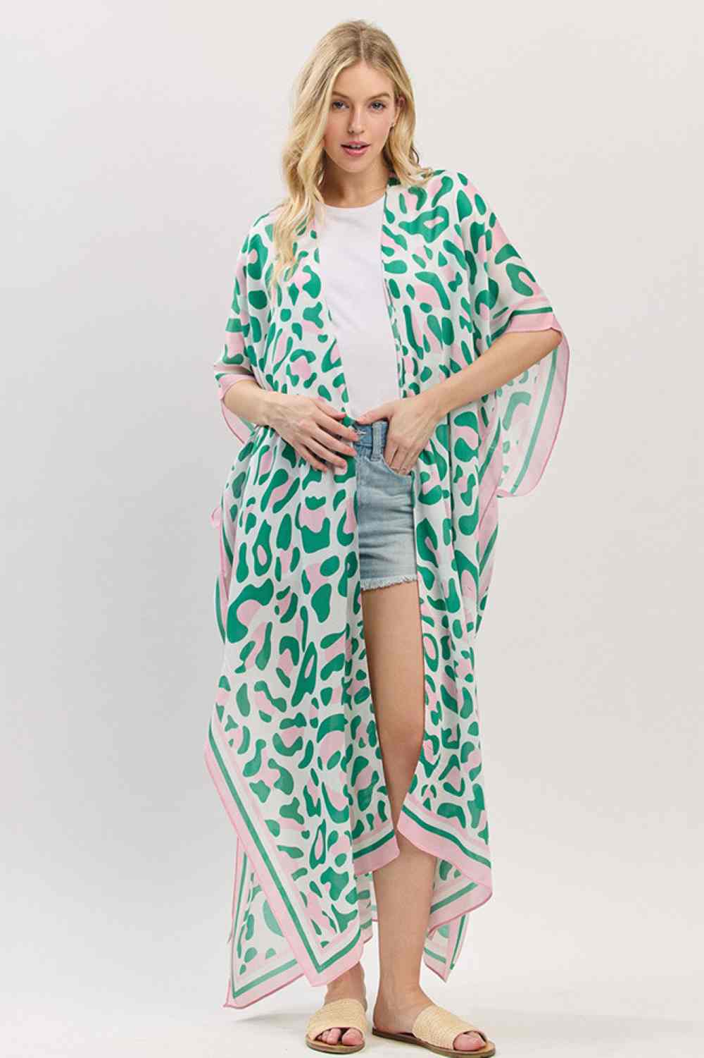 Pink Green Effortless summer style meets timeless leopard print in this lightweight open-front kimono. Crafted from breathable 100% polyester, it drapes beautifully over swimwear or casual outfits for an instant beach-ready look. The generous 35" x 47.5" dimensions provide comfortable coverage without bulk, making it perfect for layering on warm days. Whether you're heading to the shore or poolside, this versatile piece transitions seamlessly from day to evening wear.