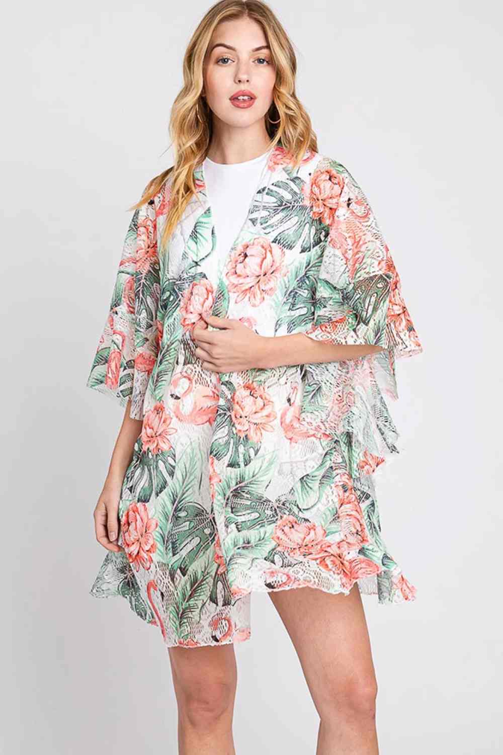 Pink Embrace tropical vibes with this stunning open-front crochet cover up, featuring a vibrant flamingo print that brings paradise to your poolside look. The delicate ruffle lining adds feminine charm and movement, while the lightweight 100% polyester construction keeps you cool and comfortable. Perfect for layering over swimwear or beach dresses, this versatile piece transitions effortlessly from beach to brunch. Dimensions: 35" x 32.5".