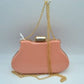 Pink This elegant evening clutch bag features a vibrant glossy hard-shell finish and a structured, curved silhouette, making it a sophisticated addition to any special occasion. The secure top frame is fastened with a striking rectangular gold-tone clasp adorned with sparkling rhinestones. Equipped with a delicate, detachable metallic chain-link shoulder strap, this sleek accessory offers a classic look and convenient hands-free styling options.
