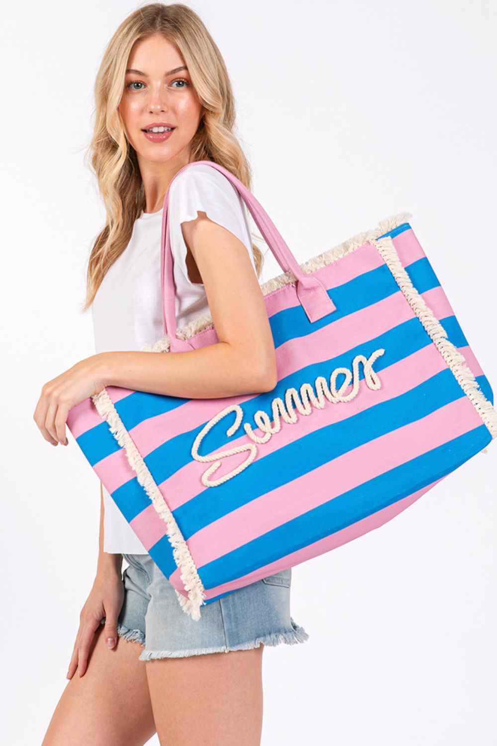 Pink Carry your summer essentials in style with this SUMMER Sewn Rope Striped Pattern Tote Bag. Featuring a classic striped design with decorative rope detailing and playful fringe trim, this versatile bag is perfect for beach days, shopping trips, or casual outings. Crafted from durable 100% polyester, it measures 17.5" x 14" x 5" spacious enough for all your needs. The magnetic closure keeps your belongings secure, while the inner pocket provides convenient organization. Whether you're heading to the shor