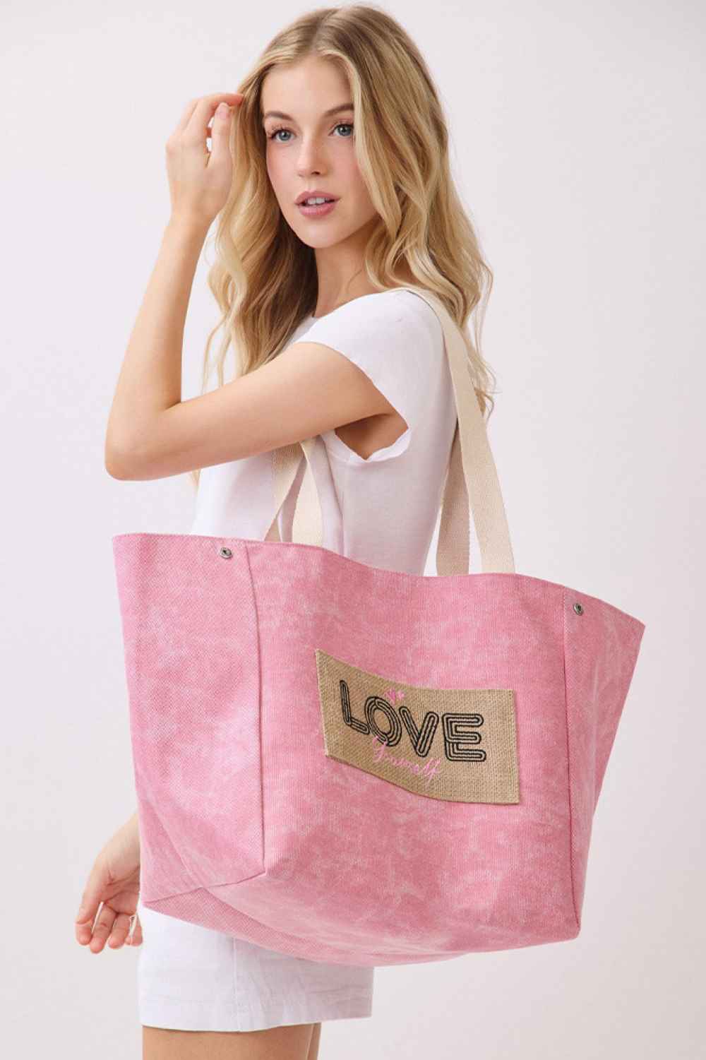 Pink Carry your message in style with this versatile shoulder and bucket-style canvas tote. Crafted from a durable 90% polyester and 10% burlap blend, this bag features the empowering "LOVE YOURSELF" letter design. Measuring 22" x 13" x 9.5", it offers ample space for daily essentials, work, or travel. The magnetic snap closure keeps your belongings secure, while the inner pocket provides convenient organization. Perfect for anyone seeking a functional accessory that doubles as a daily affirmation.