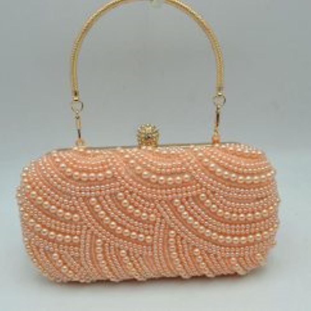Pink This structured clutch bag features an intricately embellished exterior designed in a distinctive wavy, textured pattern. A rigid, rounded top handle is secured to the frame with small loops, offering a classic carrying style suitable for special events or elevated everyday use. The bag is completed with a decorative top clasp closure that secures the main storage compartment, providing a functional and polished accessory.