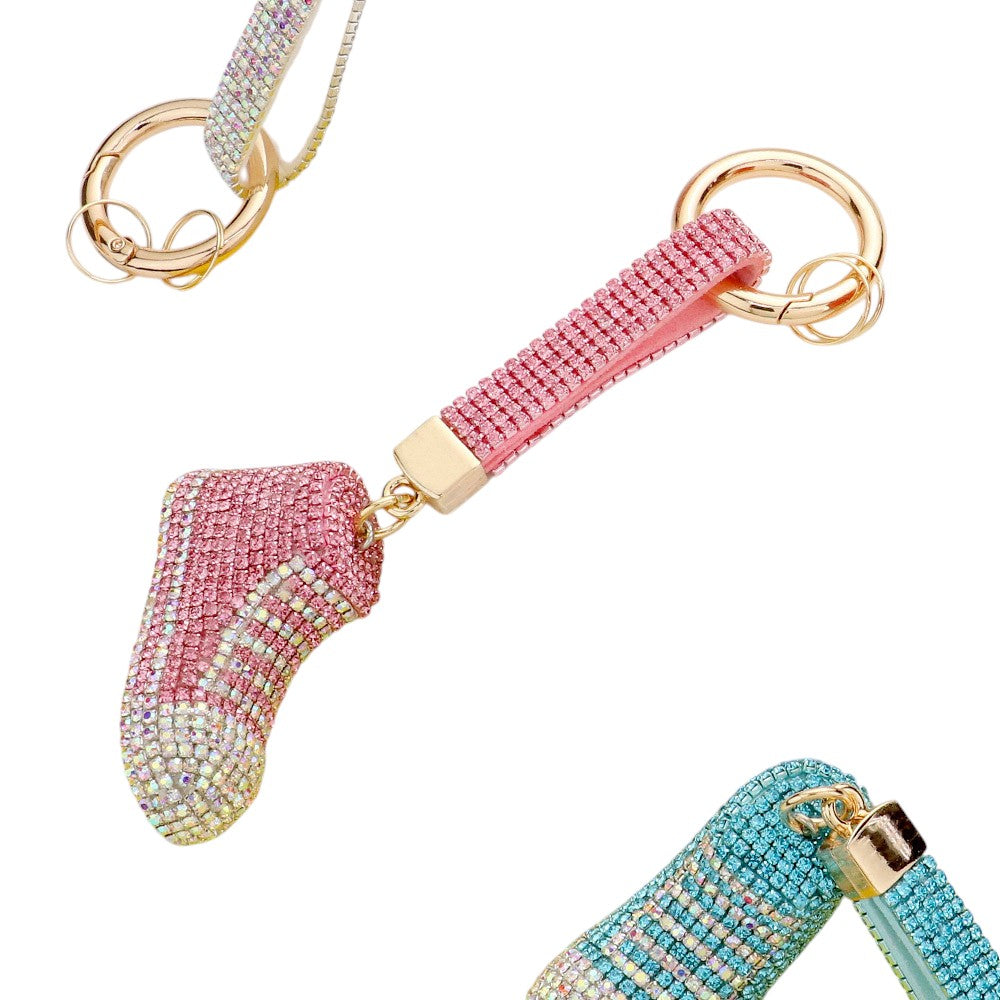 Pink Rhinestone Pave Sneaker Bag Charm features a sparkling rhinestone pave design that is sure to add a touch of glamour to any bag. The charm is perfect for sneaker lovers and fashionistas alike, making it a versatile and stylish accessory. With its high-quality construction, this charm is a must-have for any fashion-forward individual.