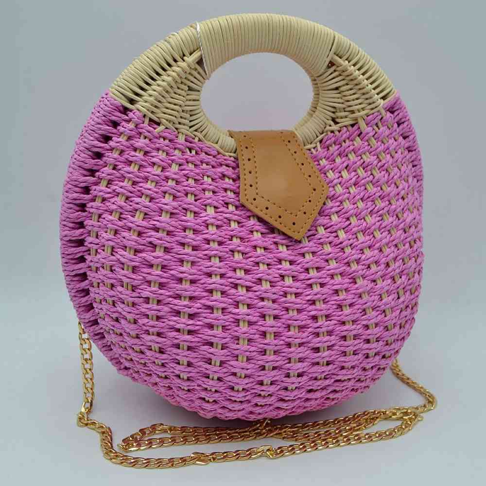 Purple Bring a chic, geometric flair to your summer style with this stunning round woven basket bag. Showcasing an eye-catching circular silhouette and rich, multi-tonal straw weaving, this handbag is the quintessential accessory for resort getaways, beach days, or sunny afternoon strolls. Blending bohemian textures with elegant hardware accents, it serves as a versatile piece that easily elevates a breezy maxi dress or a casual linen ensemble.