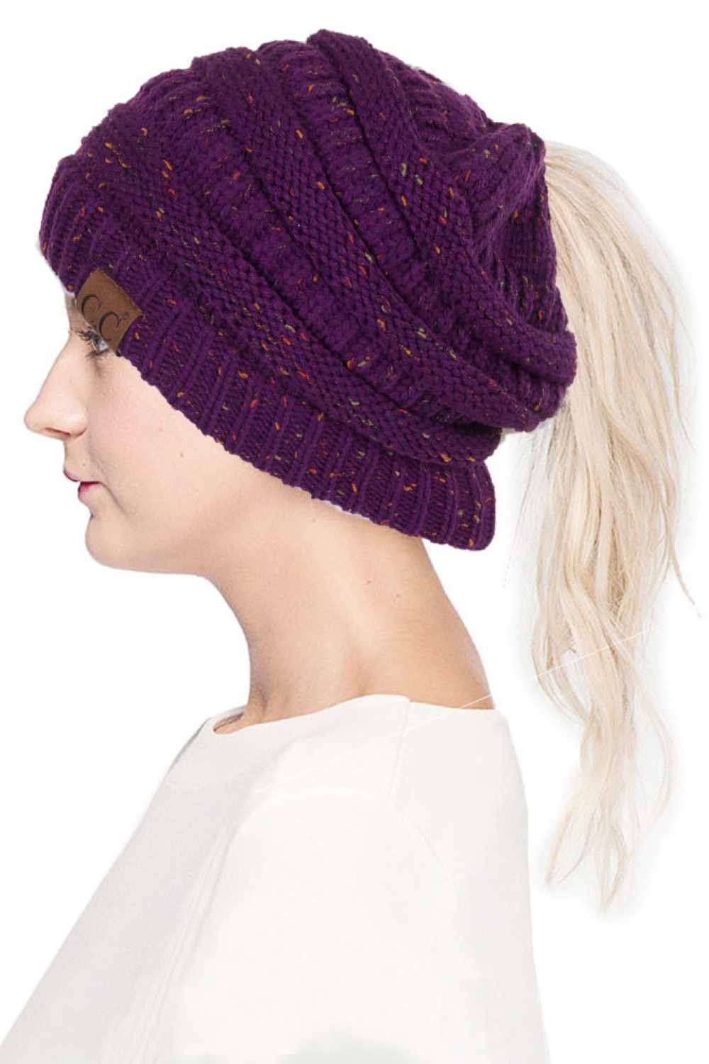 Purple The C.C Confetti Ponytail Messy Bun Beanie features a soft knit design with subtle confetti flecks for a fun, playful look. Designed with a convenient opening for ponytails or messy buns, it keeps you warm while allowing you to style your hair comfortably.