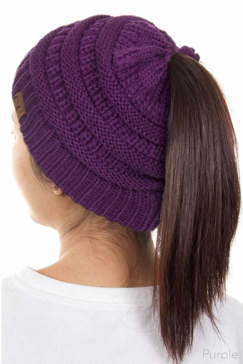 Purple The C.C Solid Color Ponytail Messy Bun Beanie combines comfort with versatility for effortless everyday style. Crafted from 100% soft acrylic, this beanie features an open crown design that accommodates ponytails and messy buns while keeping you warm. The one-size-fits-most construction ensures a secure, flattering fit for virtually anyone. Perfect for casual outings, workouts, or relaxed weekends, this practical accessory transitions seamlessly from season to season.
