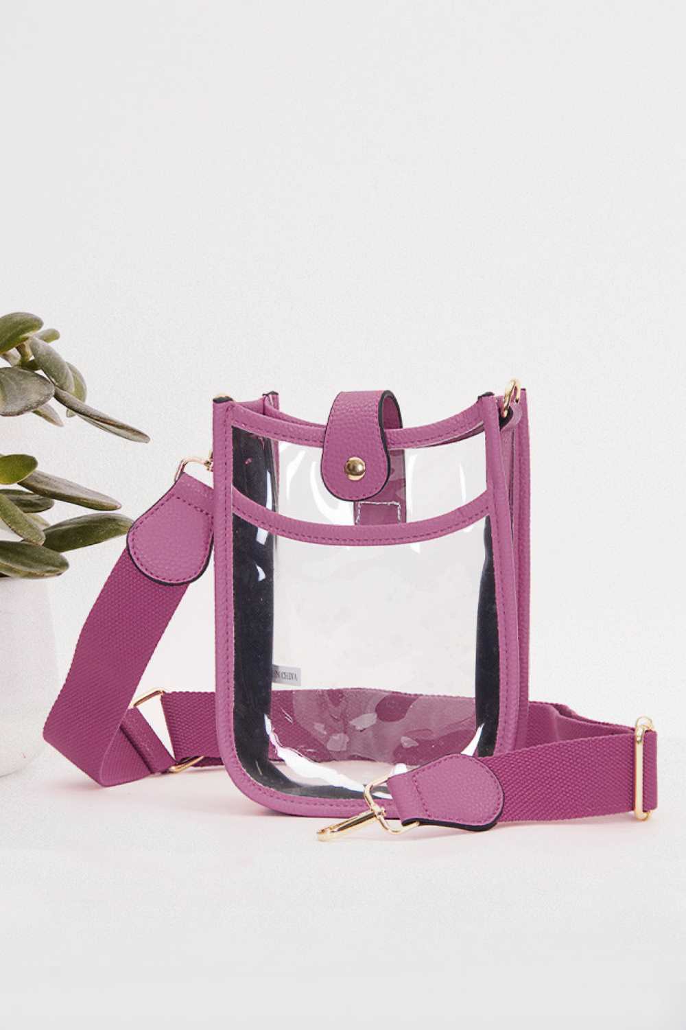 Purple Perfect for concert season and stadium events, this clear crossbody mini bag meets all venue security requirements while keeping your essentials within reach. Crafted from durable 100% PVC, it's easy to clean and built to last through countless outings. Compact yet functional at 8" x 5.8" x 2.3", the adjustable crossbody strap sits comfortably across your body, leaving your hands free. The transparent design lets you quickly locate your phone, keys, and small valuables at a glance.