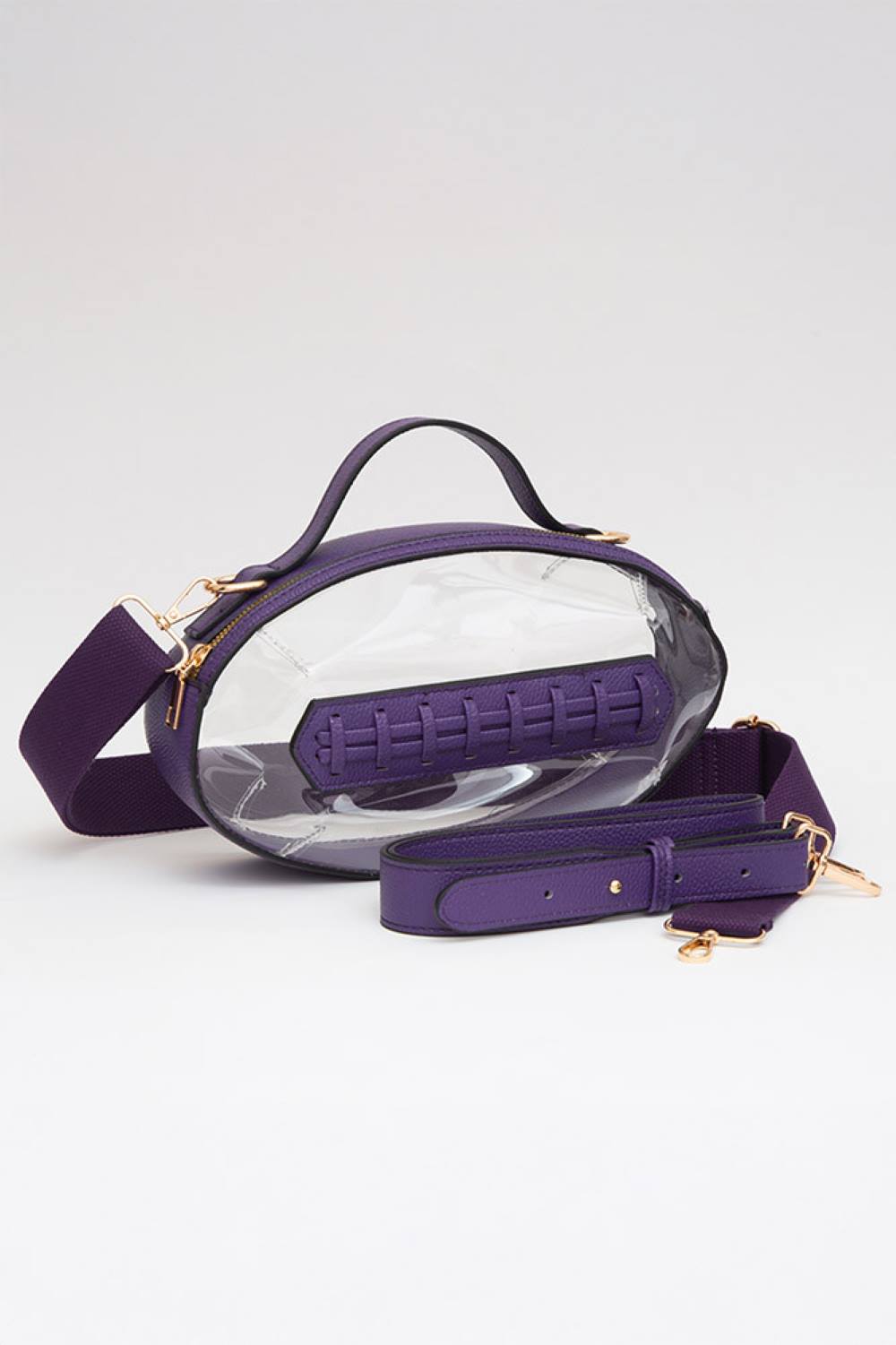 Purple Carry your essentials in style with this unique football-shaped transparent crossbody bag. Perfect for stadium events, concerts, and outdoor gatherings, the clear PVC design lets you see everything inside while meeting venue security requirements. Measuring 11" x 6" x 4", it offers practical storage without bulk. The adjustable crossbody strap keeps your hands free, making it ideal for busy days out. Durable 100% PVC construction ensures long-lasting wear through countless adventures.