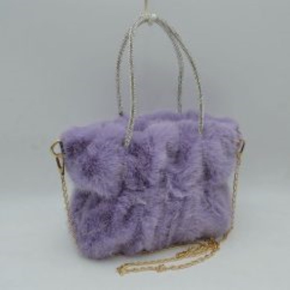 Purple This unique everyday handbag features a soft, dense plush exterior that brings a cozy texture and modern look to your accessory collection. Designed with a slouchy, gathered silhouette, it features a central main storage compartment to keep your daily items within easy reach. The bag stands out with dual top handles covered in shimmering rhinestone details for elegant hand carrying, alongside a detachable metallic chain strap that offers versatile hands-free shoulder wear.