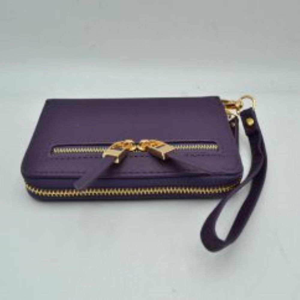 Purple This practical everyday wallet clutch features a structured rectangular design equipped with multiple storage compartments to keep your essentials organized. It includes a secure main wrap-around zipper closure alongside a distinct dual-zipper front accent pocket featuring metallic pulls with extended tabs. Designed for effortless hands-free carrying, it comes with a detachable, textured wristlet strap connected by a metallic clasp, combining convenience and contemporary style for daily use.