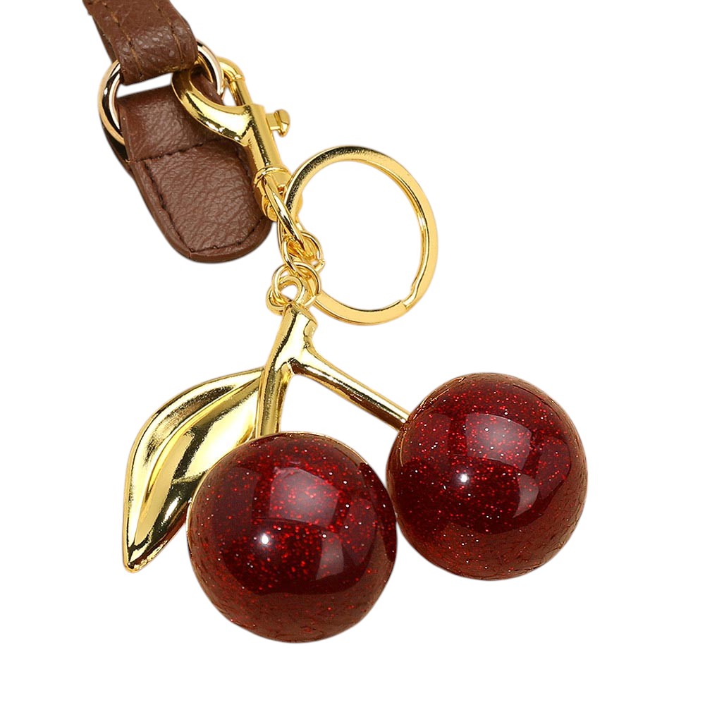 Red Glittered Cherry Bag Charm is the perfect accessory to add some sparkle to your bag. The glitter adds a touch of glam, while the cherry design is both playful and stylish. With this charm, your bag will not only stand out, but you'll also be on-trend. 