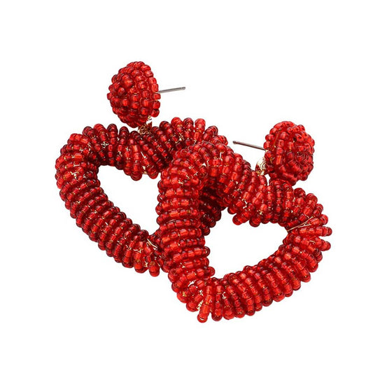 Red Seed Beaded Chunky Open Heart Dangle Earrings, are perfect for adding a touch of glamour to your look. The high-quality beads create a unique texture and are sure to add a statement to any ensemble. The lightweight earrings are comfortable and feature secure metal clasps, perfect for all-day wear.