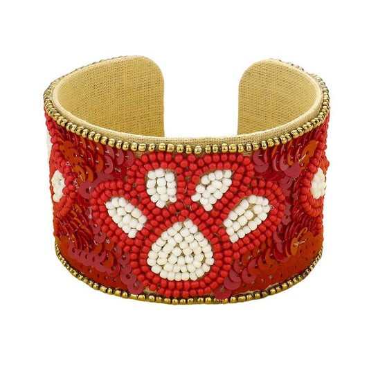 Red White This stylish Game Day Sequin Seed Beaded Paw Accented Cuff Bracelet is the perfect way to show your team spirit. Crafted with sparkling sequins and beads, this bracelet features an eye-catching paw accent, perfect for any sports fan. Show your true allegiance on game day with this fashionable and unique accessory.