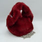 Red This unique everyday handbag showcases an eye-catching, ultra-soft plush exterior that brings a cozy, tactile texture to your accessory collection. Designed with a structured, rounded silhouette, it includes an integrated top cutout handle woven seamlessly into the form for easy hand carrying, alongside a separate metallic chain strap for versatile alternative styling options. The top opening provides straightforward access to the central main storage compartment