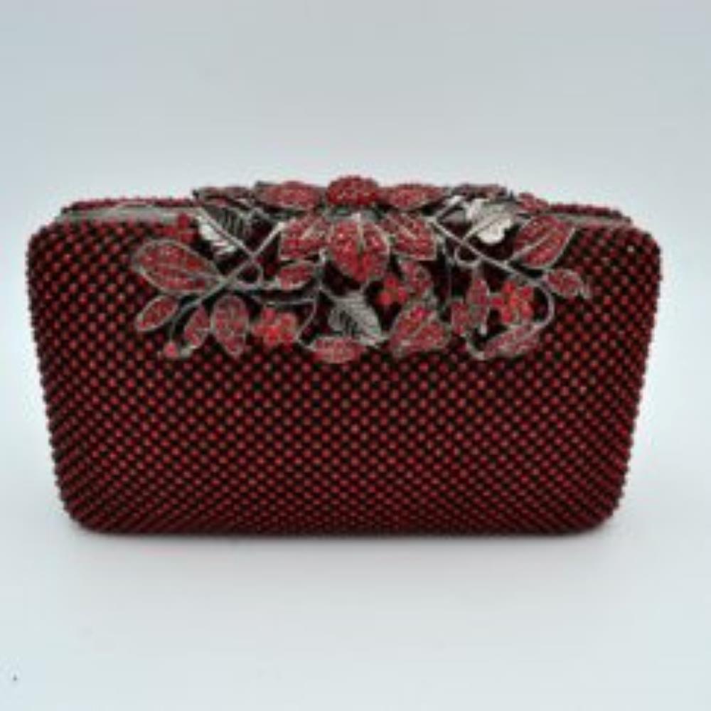 Red Designed with a rigid rectangular silhouette, this sophisticated box clutch features a meticulously textured exterior composed of small, shimmering circular studs arranged in a uniform pattern. A detailed overlay consisting of metallic leaves and floral accents spans across the top closure, creating an elegant focal point while securing the main storage compartment. A matching link chain strap attaches seamlessly to the top edges
