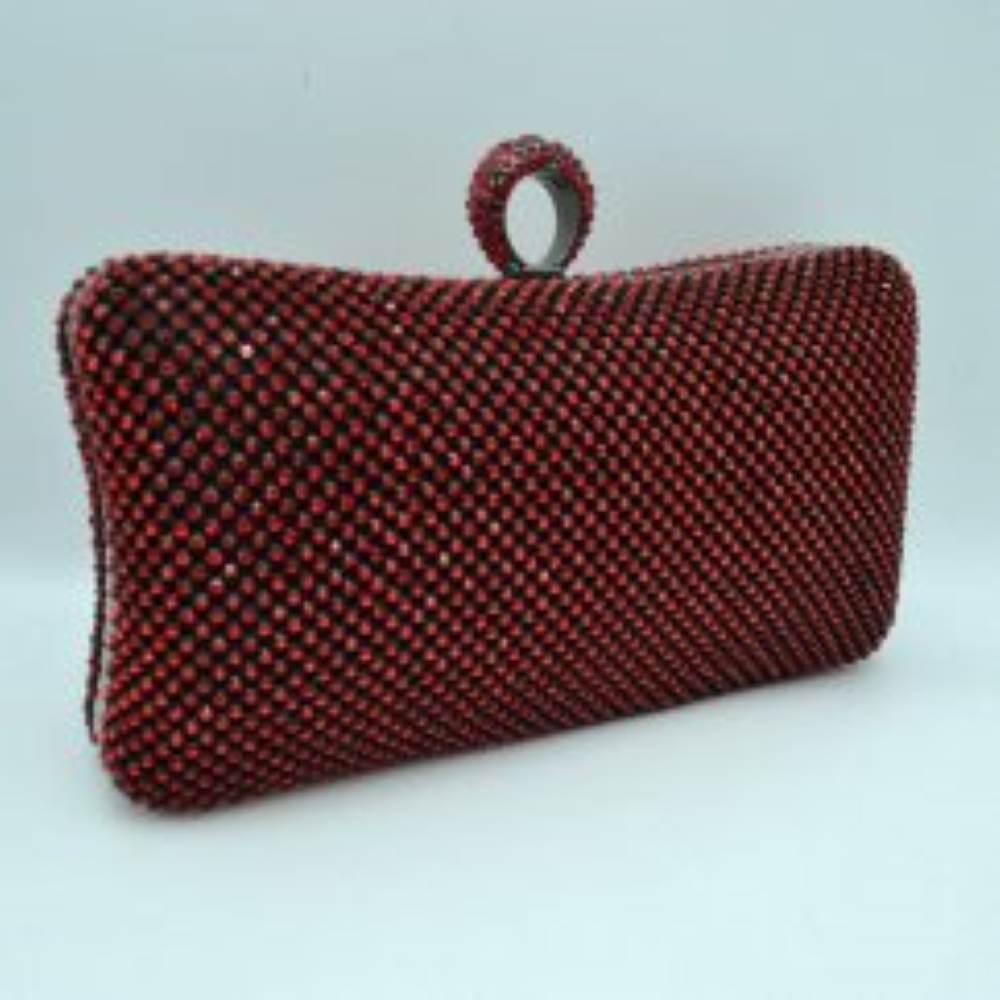 Red This hard-shell box clutch features a curved rectangular profile entirely covered in neat rows of small, shimmering circular embellishments for an elegant accent to everyday ensembles. A prominent, textured ring-style clasp sits centered at the top, serving as both a functional closure mechanism to access the interior storage compartment and an integrated finger-loop handle element for secure hand-held carrying.