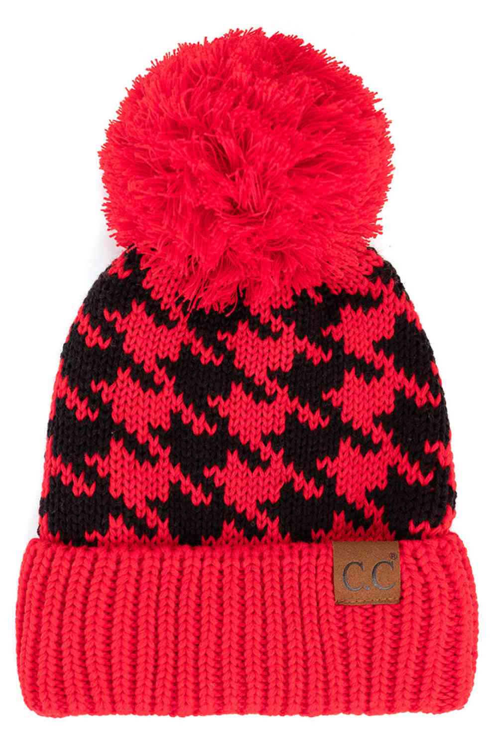 Red Black Elevate your winter wardrobe with the C.C Houndstooth Knit Beanie With Pom. This classic houndstooth pattern beanie combines timeless style with everyday comfort. Made from 100% acrylic, it's lightweight and soft against your skin. The playful pom-pom adds a charming finishing touch.