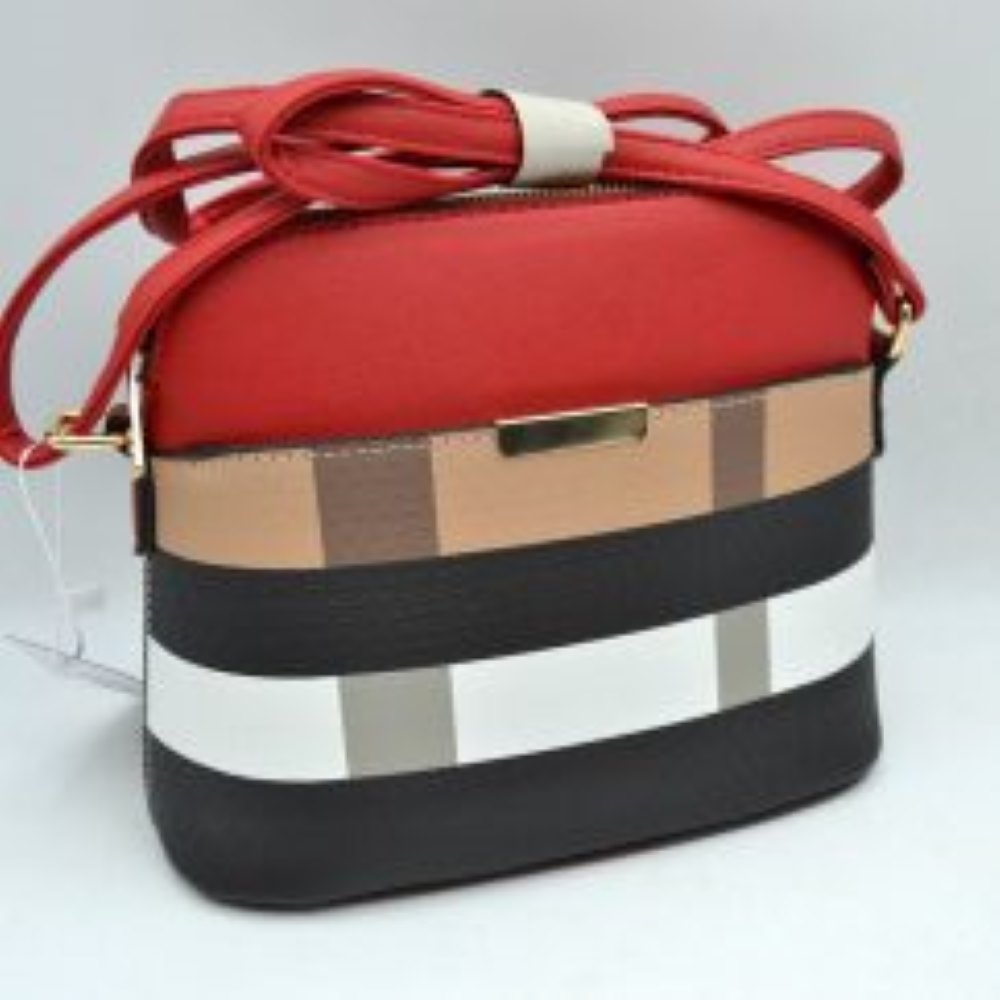 Red brown This structured shoulder bag features a multi-patterned exterior showcasing horizontal bands and vertical blocks on the lower section beneath a solid upper panel. Designed for convenient everyday use, the bag includes a front slip pocket accented with a sleek rectangular hardware trim and a secure top zipper closure for the main storage compartment. A long, adjustable strap is connected via side rings and a buckle, allowing for versatile crossbody carrying options.