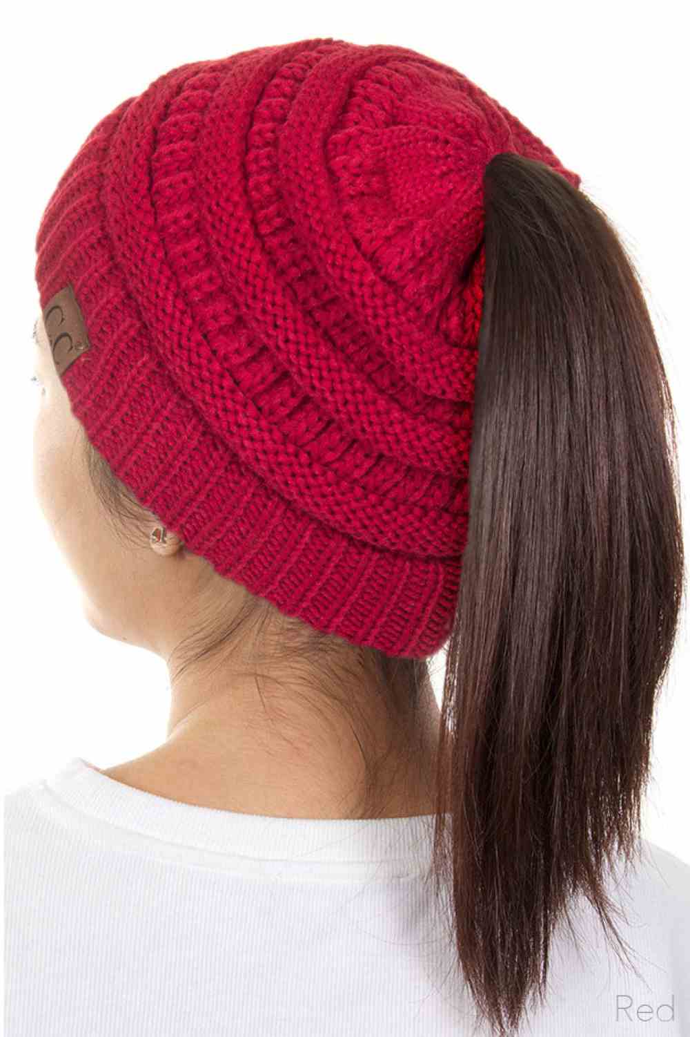 Red The C.C Solid Color Ponytail Messy Bun Beanie combines comfort with versatility for effortless everyday style. Crafted from 100% soft acrylic, this beanie features an open crown design that accommodates ponytails and messy buns while keeping you warm. The one-size-fits-most construction ensures a secure, flattering fit for virtually anyone. Perfect for casual outings, workouts, or relaxed weekends, this practical accessory transitions seamlessly from season to season.