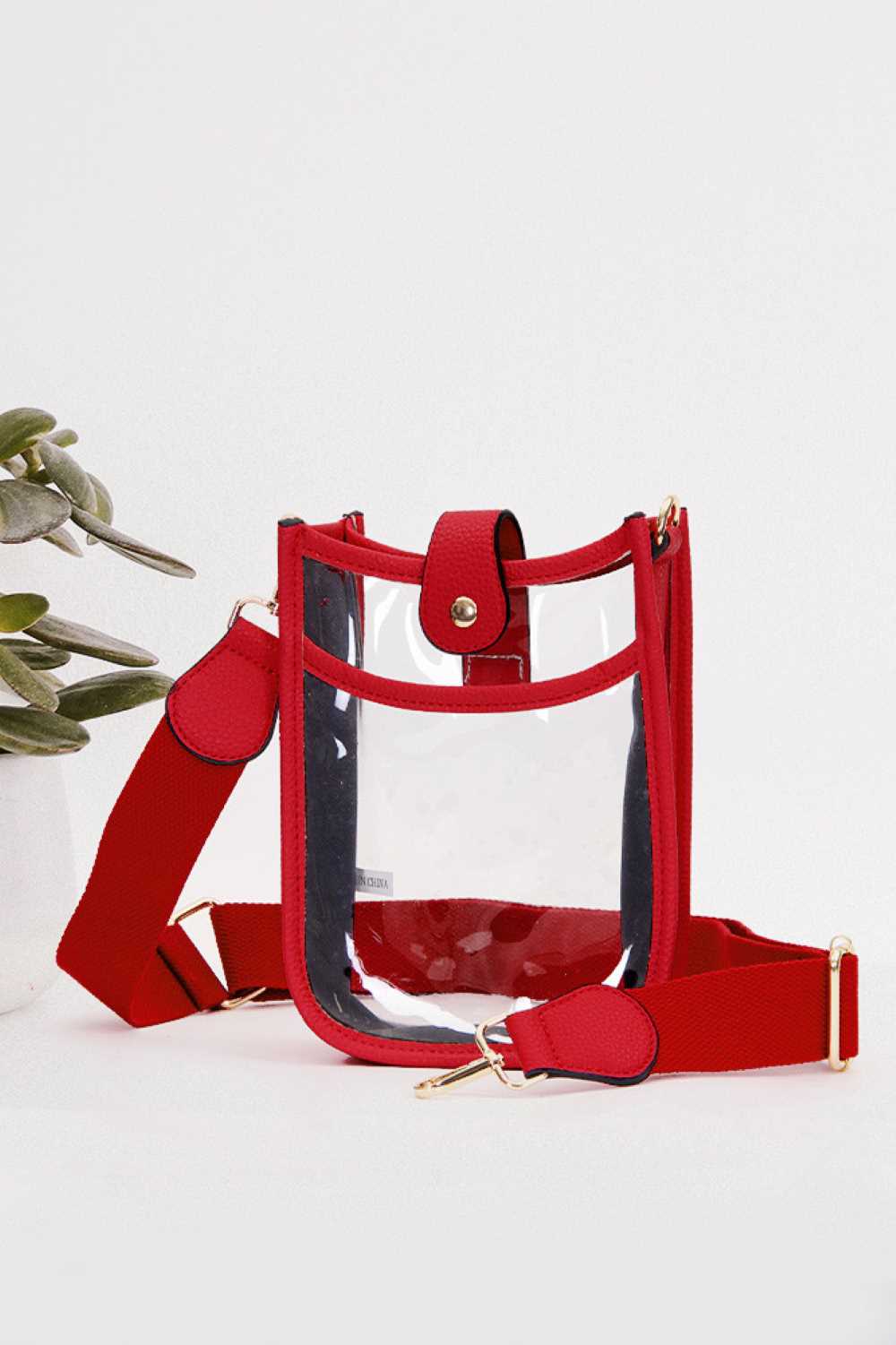 Red Perfect for concert season and stadium events, this clear crossbody mini bag meets all venue security requirements while keeping your essentials within reach. Crafted from durable 100% PVC, it's easy to clean and built to last through countless outings. Compact yet functional at 8" x 5.8" x 2.3", the adjustable crossbody strap sits comfortably across your body, leaving your hands free. The transparent design lets you quickly locate your phone, keys, and small valuables at a glance.